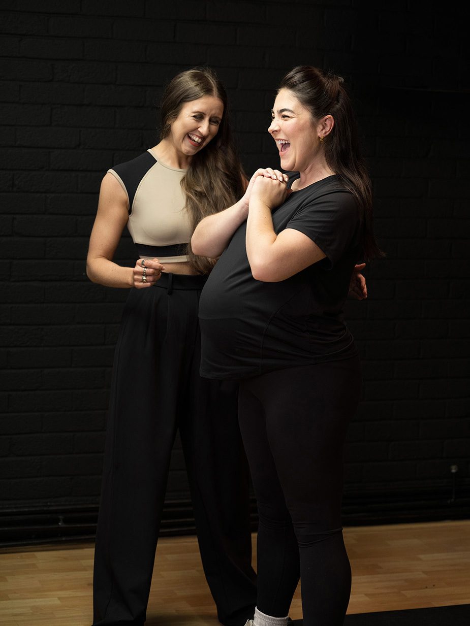 Elin Wyn laughing with a pregnant client at The Pontcanna Gym
